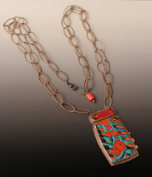 One-of-a-kind polymer pendant of reds, oranges, turquoise, with oxidized silver and coral bead at back.